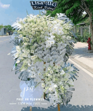 Kệ hoa chia buồn lan hồ điệp trắng hai tầng, hoa tang lễ tông trắng trang nghiêm, kệ hoa viếng sang trọng thanh khiết, hoa chia buồn thiết kế hiện đại, đặt hoa tang lễ giao nhanh tận nơi